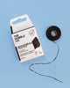 The Humble Co. Charcoal Dental Floss on a blue background, featuring a sleek design and, eco-friendly packaging